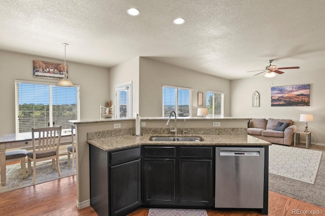 9233 Waters Edge Dr, Fountain, CO 80817 - kitchen featuring stainless steel dishwasher, a textured ceiling, open floor plan, ceiling fan, and plenty of natural light