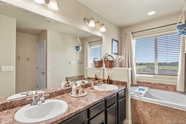 9233 Waters Edge Dr, Fountain, CO 80817 - bathroom with healthy amount of natural light, double vanity, and a garden tub