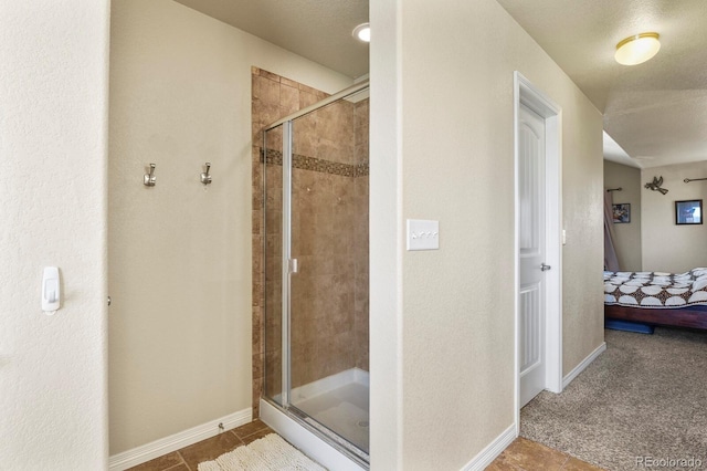 9233 Waters Edge Dr, Fountain, CO 80817 - bathroom featuring connected bathroom, a stall shower, and tile patterned flooring