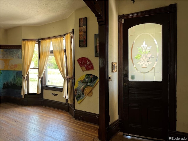 entrance foyer featuring a textured ceiling and hardwood / wood-style floors