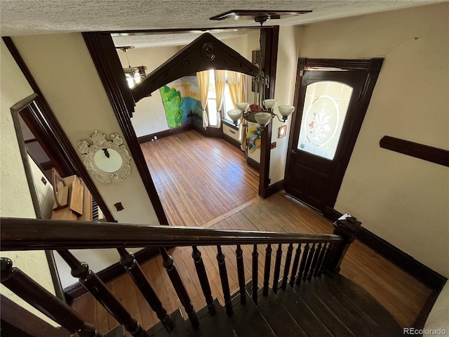 entryway featuring wood-type flooring and a textured ceiling