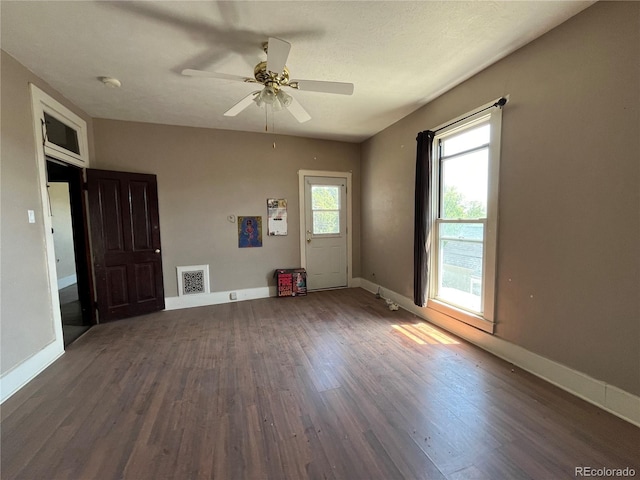 empty room featuring dark hardwood / wood-style floors and ceiling fan