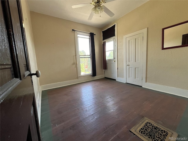 spare room with ceiling fan and dark hardwood / wood-style flooring