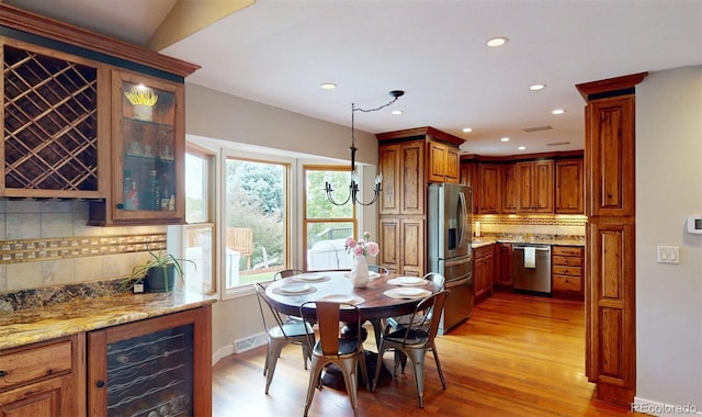 6278 E Euclid Ave, Centennial, CO 80111 - dining room with wine cooler, a dry bar, light wood finished floors, and recessed lighting