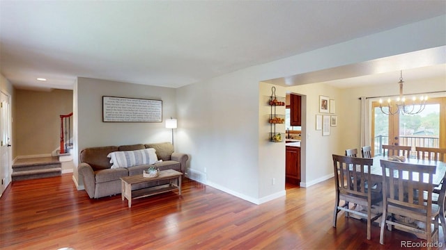 6278 E Euclid Ave, Centennial, CO 80111 - living room featuring wood finished floors, a chandelier, baseboards, stairs, and recessed lighting