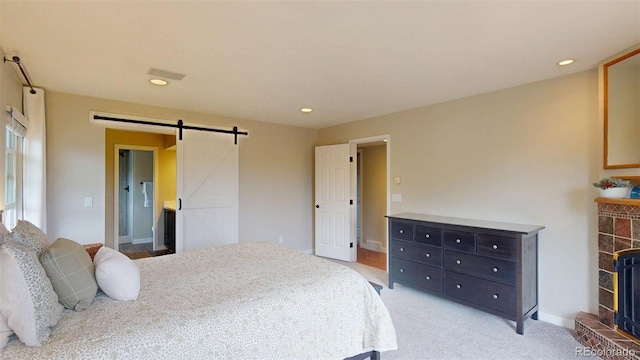 6278 E Euclid Ave, Centennial, CO 80111 - bedroom with a barn door, recessed lighting, light colored carpet, baseboards, and a fireplace with raised hearth