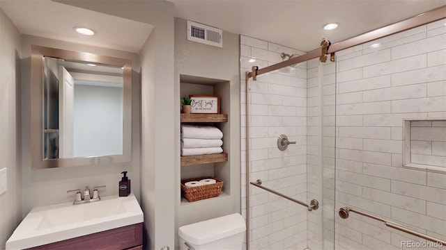 6278 E Euclid Ave, Centennial, CO 80111 - bathroom featuring toilet, vanity, a stall shower, and recessed lighting
