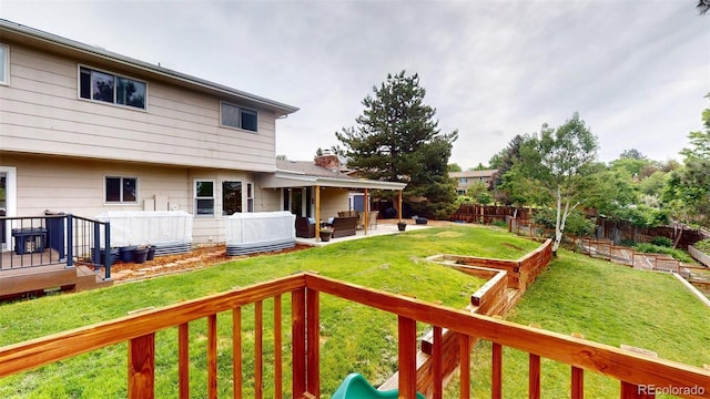6278 E Euclid Ave, Centennial, CO 80111 - view of yard featuring a vegetable garden, an outdoor hangout area, and a deck