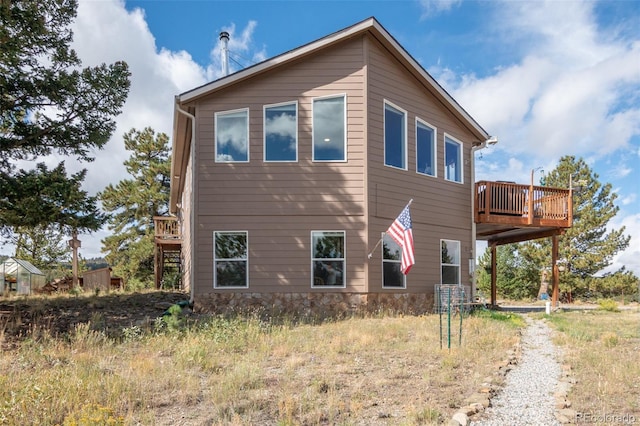 view of side of property featuring a wooden deck