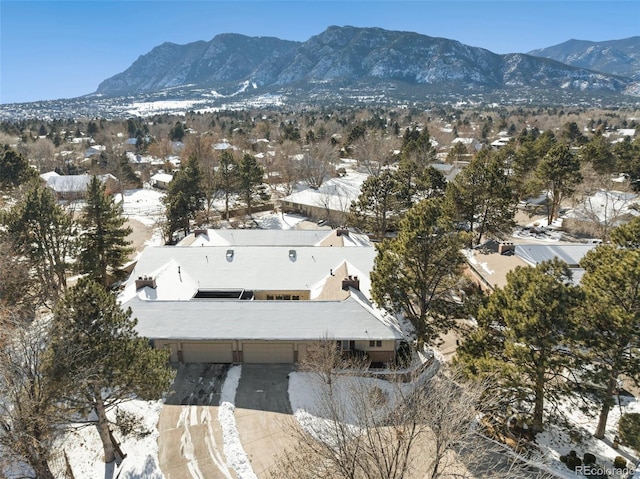 snowy aerial view with a mountain view