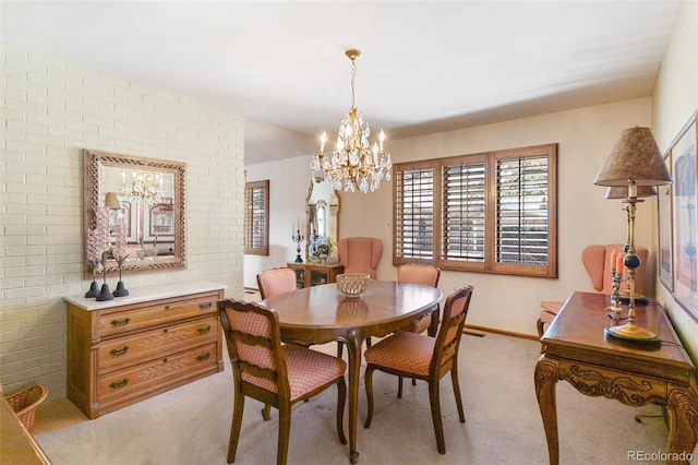 carpeted dining room featuring a chandelier and brick wall