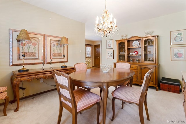 dining room with light carpet and a notable chandelier