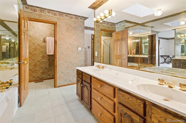 bathroom featuring vanity, tile patterned flooring, and a skylight