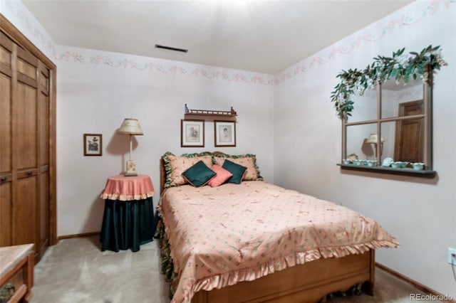 bedroom with light colored carpet and a closet