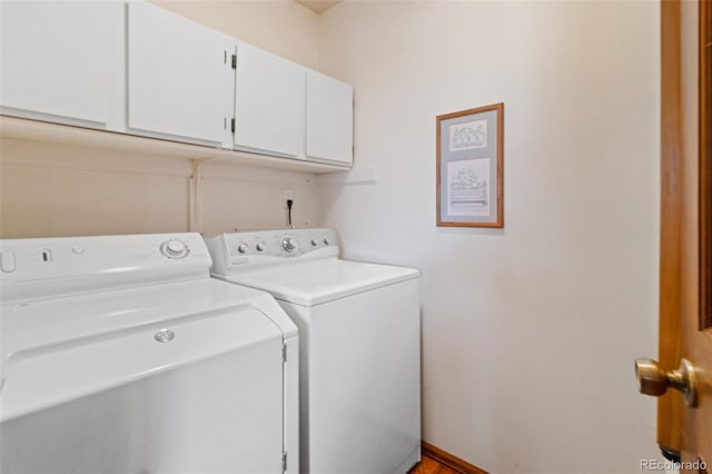 washroom featuring cabinets and washer and dryer