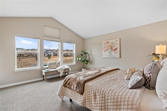 carpeted bedroom featuring lofted ceiling and baseboards