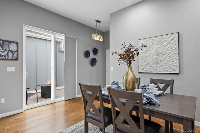 dining space with wood finished floors and baseboards