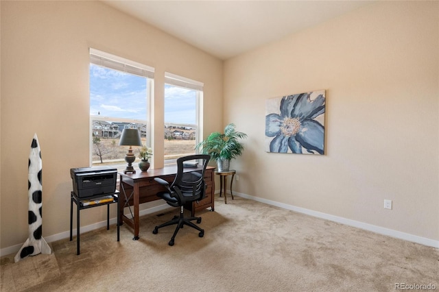 carpeted home office with baseboards