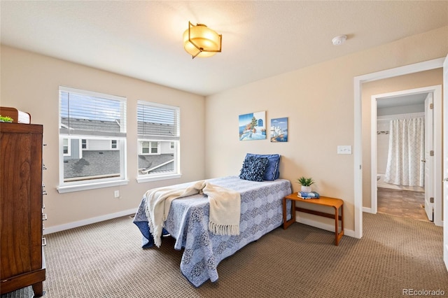 carpeted bedroom featuring baseboards