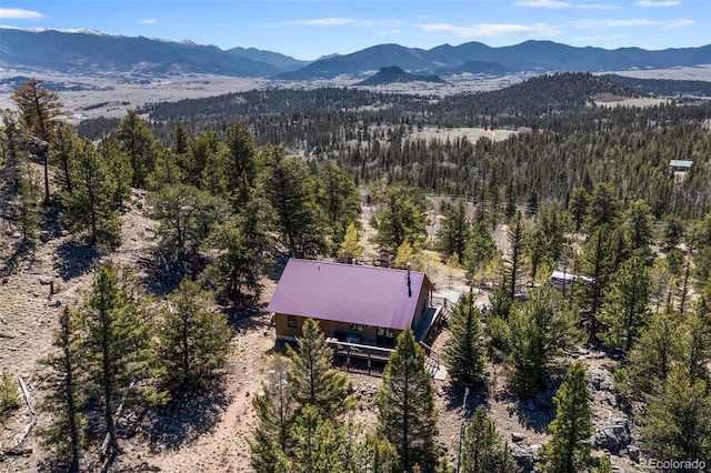 1838 E Longbow Dr, Como, CO 80432 - aerial view of property and surrounding area featuring a forest and a mountainous background