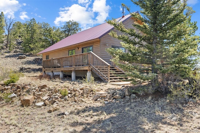 1838 E Longbow Dr, Como, CO 80432 - view of front of property with faux log siding, metal roof, stairs, and a wooden deck