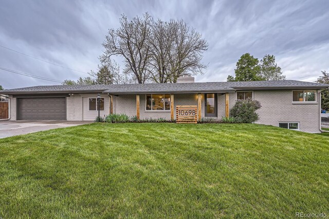 10698 W 26th Ave, Lakewood, CO 80215 - view of front of property with brick siding, an attached garage, a front yard, a chimney, and driveway