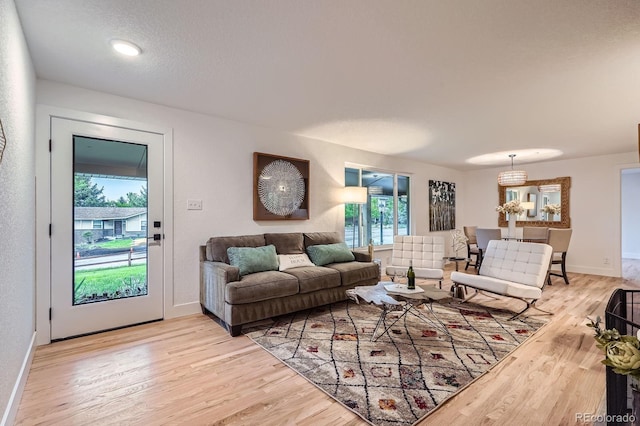 10698 W 26th Ave, Lakewood, CO 80215 - living area featuring light wood-type flooring and baseboards
