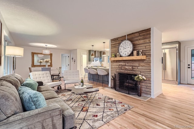 10698 W 26th Ave, Lakewood, CO 80215 - living room with light wood-type flooring and a stone fireplace