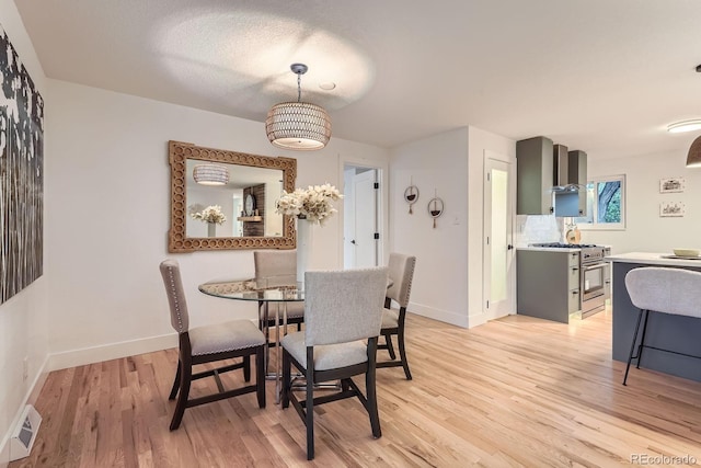 10698 W 26th Ave, Lakewood, CO 80215 - dining space with light wood-style flooring and baseboards