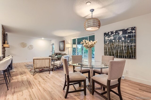 10698 W 26th Ave, Lakewood, CO 80215 - dining space featuring baseboards and light wood-style flooring