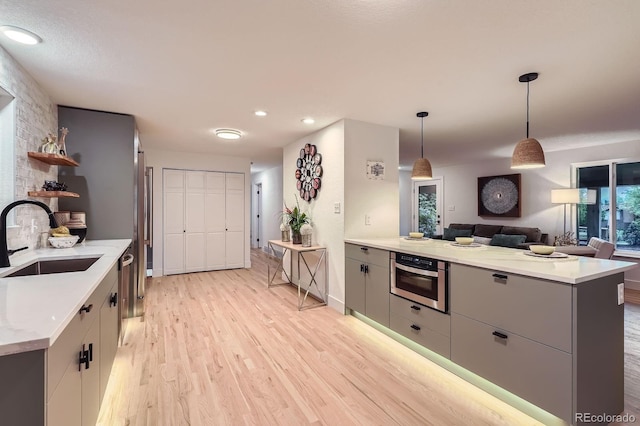 10698 W 26th Ave, Lakewood, CO 80215 - kitchen featuring a sink, gray cabinetry, light wood-style floors, light countertops, and recessed lighting