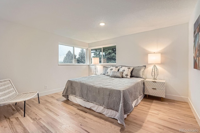 10698 W 26th Ave, Lakewood, CO 80215 - bedroom featuring light wood-style floors, baseboards, and recessed lighting