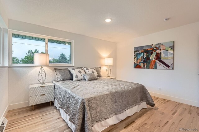 10698 W 26th Ave, Lakewood, CO 80215 - bedroom featuring light wood finished floors, baseboards, and recessed lighting