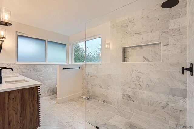 10698 W 26th Ave, Lakewood, CO 80215 - bathroom featuring tile walls, a walk in shower, and vanity