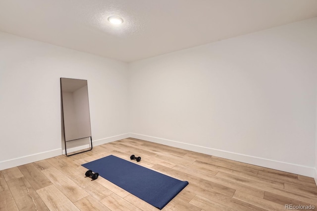 10698 W 26th Ave, Lakewood, CO 80215 - workout room featuring baseboards and light wood-type flooring