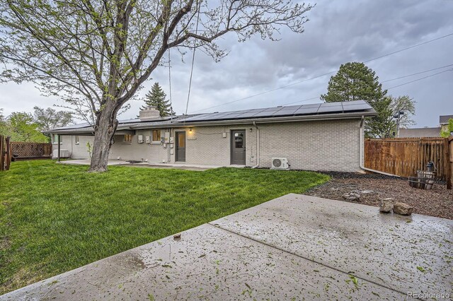 10698 W 26th Ave, Lakewood, CO 80215 - back of property featuring a patio area, solar panels, brick siding, and a chimney