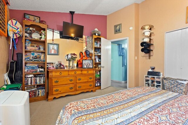 bedroom featuring lofted ceiling, light carpet, and a textured ceiling