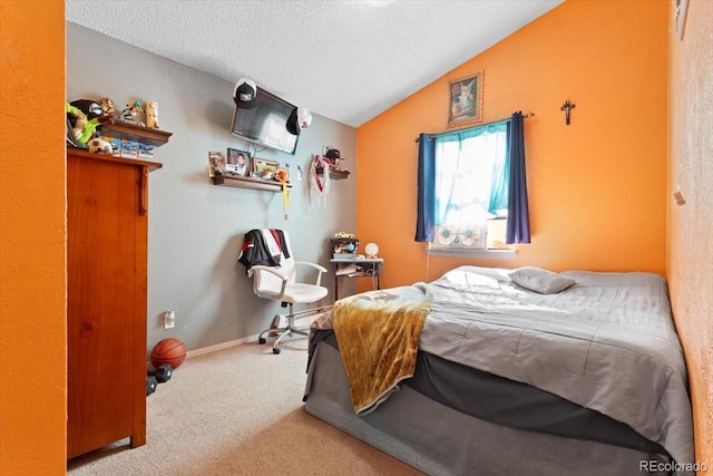 carpeted bedroom with vaulted ceiling and a textured ceiling