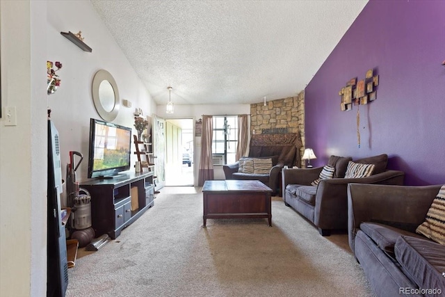 carpeted living room with a stone fireplace, vaulted ceiling, and a textured ceiling