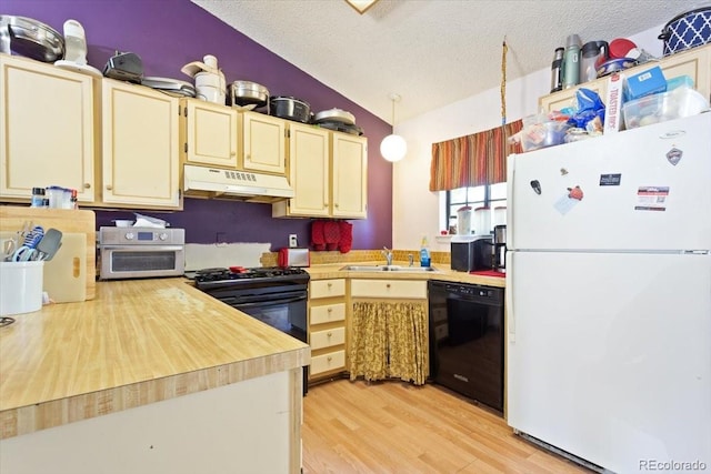 kitchen featuring a textured ceiling, lofted ceiling, light hardwood / wood-style floors, and black appliances