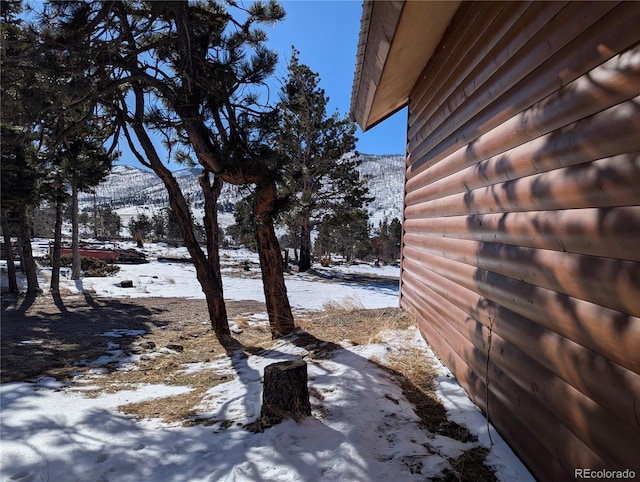 yard covered in snow with a mountain view