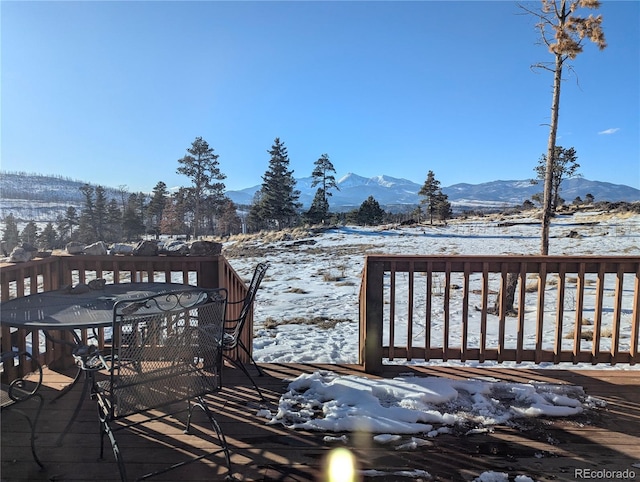 snow covered deck featuring a mountain view