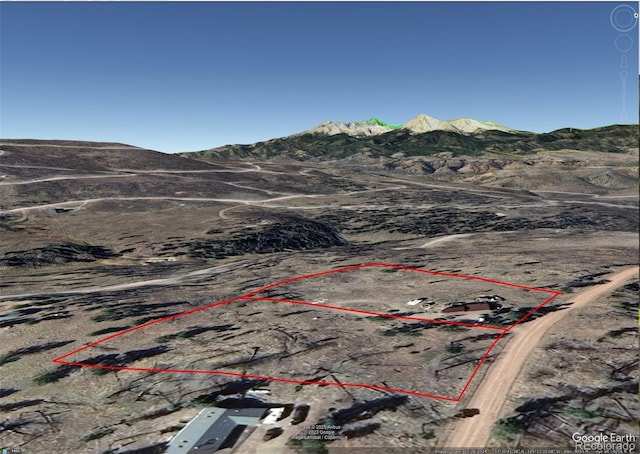 drone / aerial view featuring a mountain view