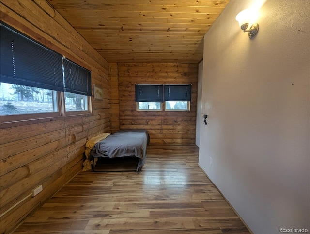 unfurnished bedroom featuring wood finished floors, vaulted ceiling, and wooden ceiling