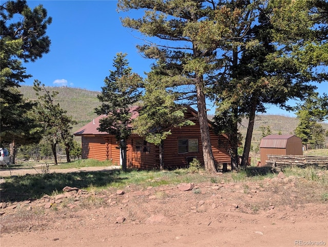 613 Macdonald Pl, Fort Garland, CO 81133 - view of side of property with log siding and a mountain view