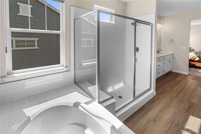 4121 River Oaks St, Castle Rock, CO 80104 - ensuite bathroom with a shower stall, wood finished floors, vanity, and a bath
