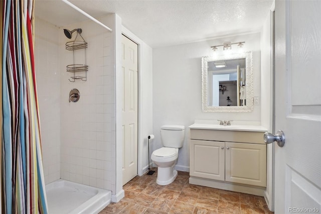 12753 Buckhorn Creek St, Parker, CO 80134 - bathroom with vanity, a tile shower, toilet, and a textured ceiling