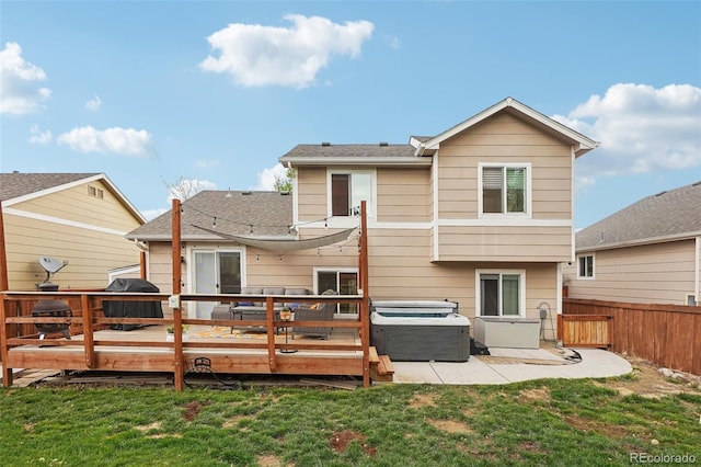 12753 Buckhorn Creek St, Parker, CO 80134 - back of property featuring a deck, a patio area, a shingled roof, and a hot tub