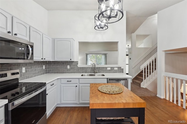 12753 Buckhorn Creek St, Parker, CO 80134 - kitchen featuring stainless steel appliances, a sink, a chandelier, and white cabinets