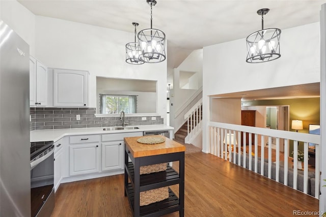 12753 Buckhorn Creek St, Parker, CO 80134 - kitchen featuring stainless steel appliances, a sink, a chandelier, light countertops, and tasteful backsplash